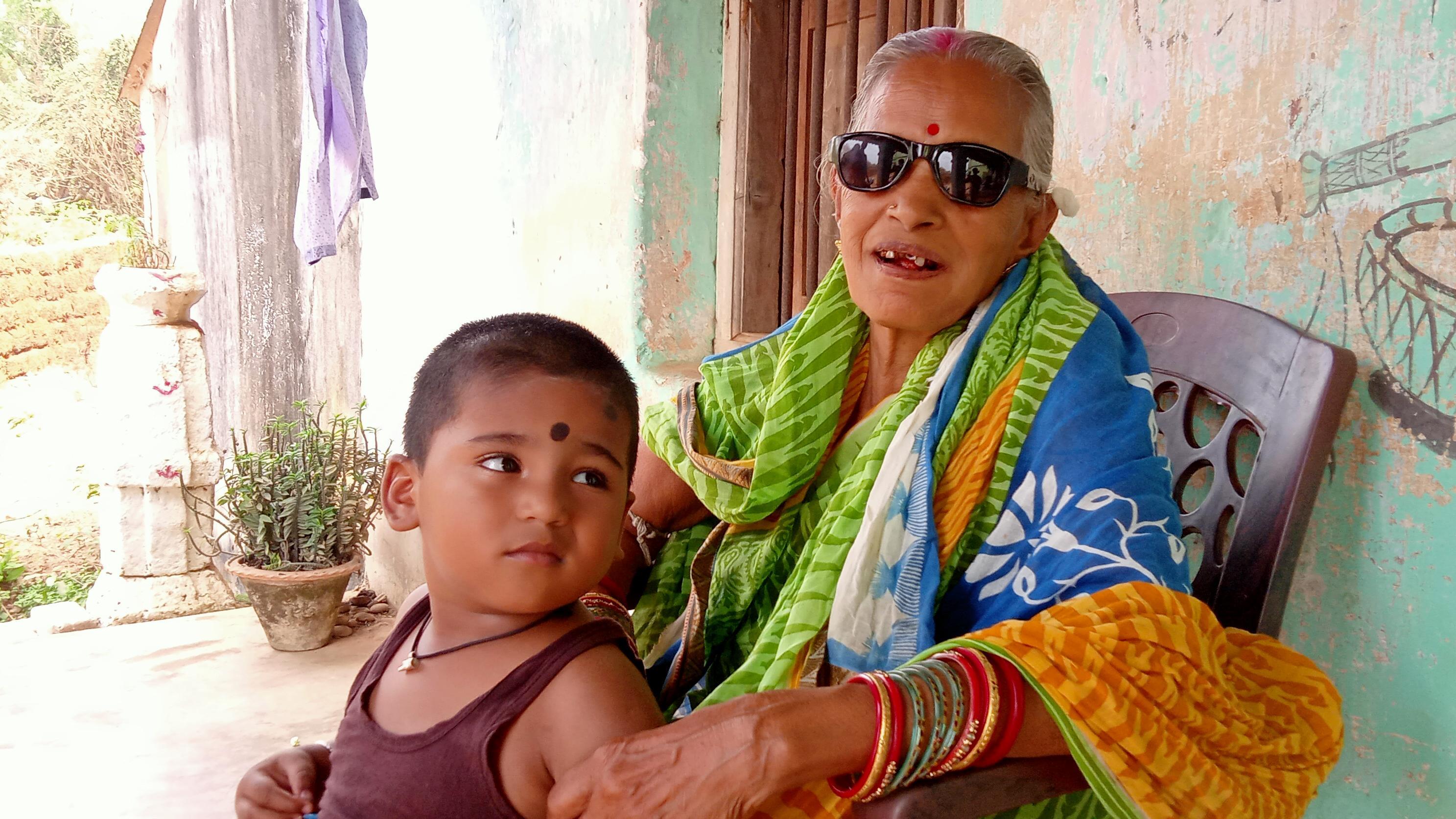 Elderly woman with sunglasses and child