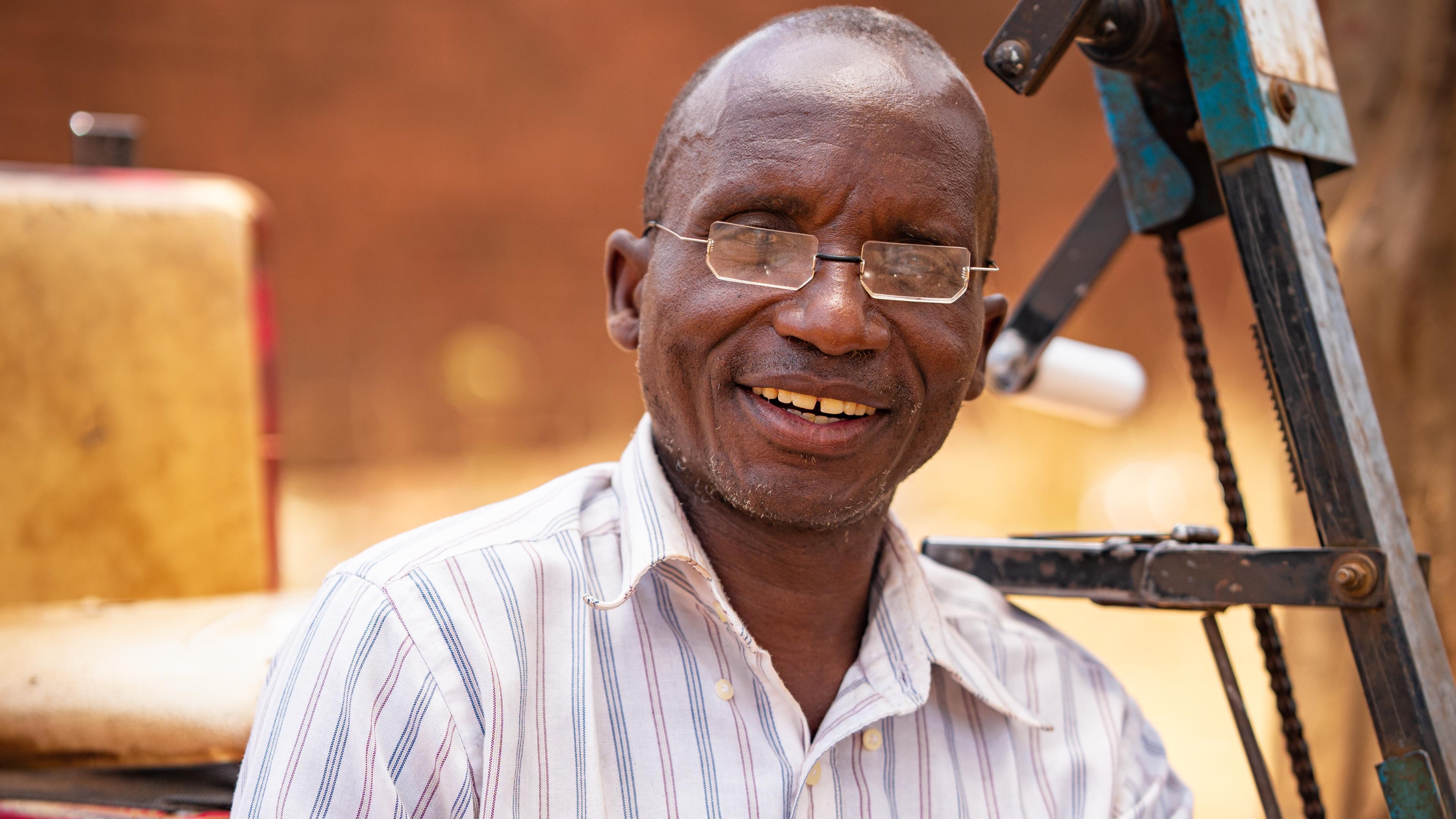 Malawian man laughs with glasses
