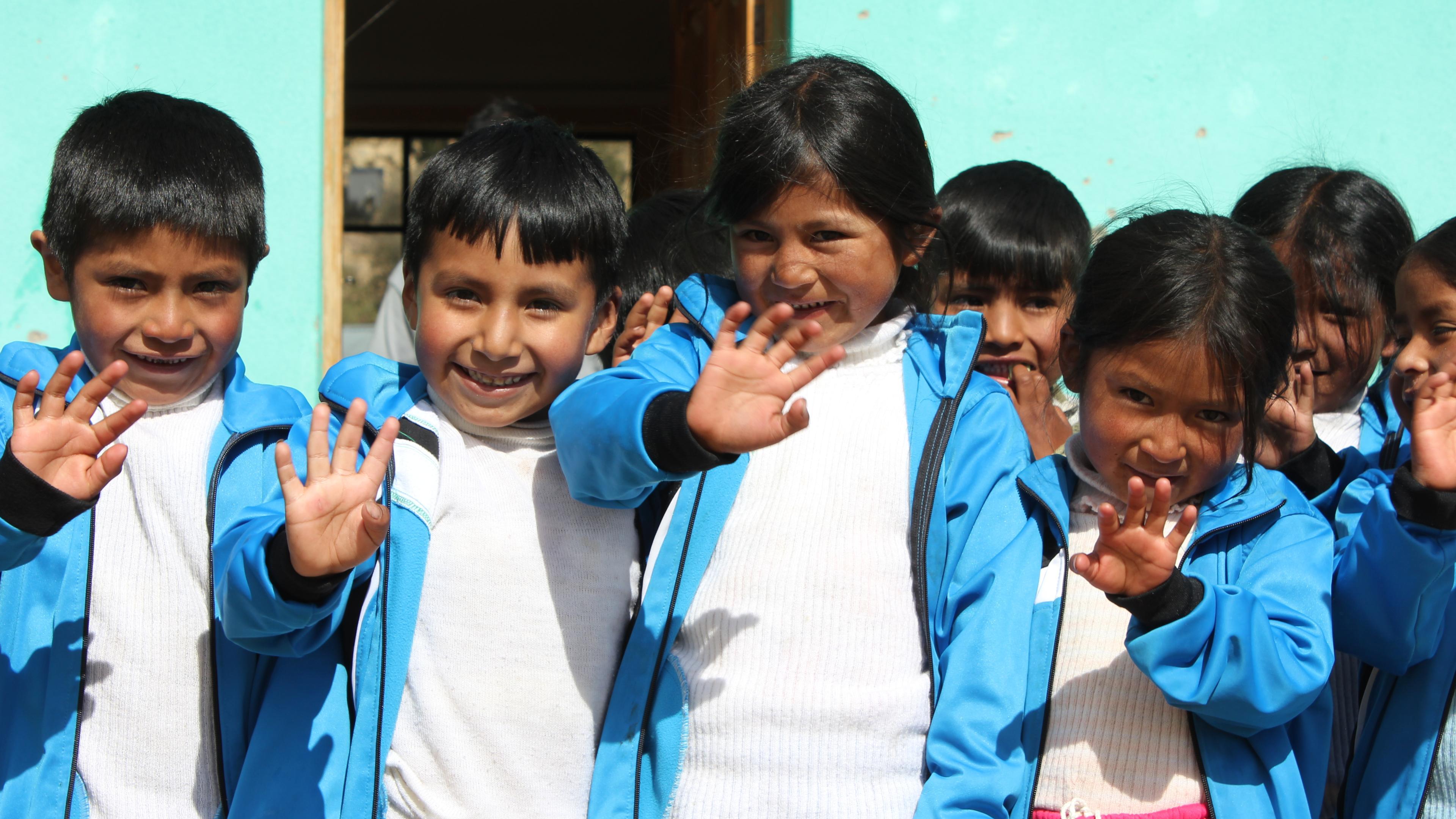 Bolivian schoolchildren wave and laugh