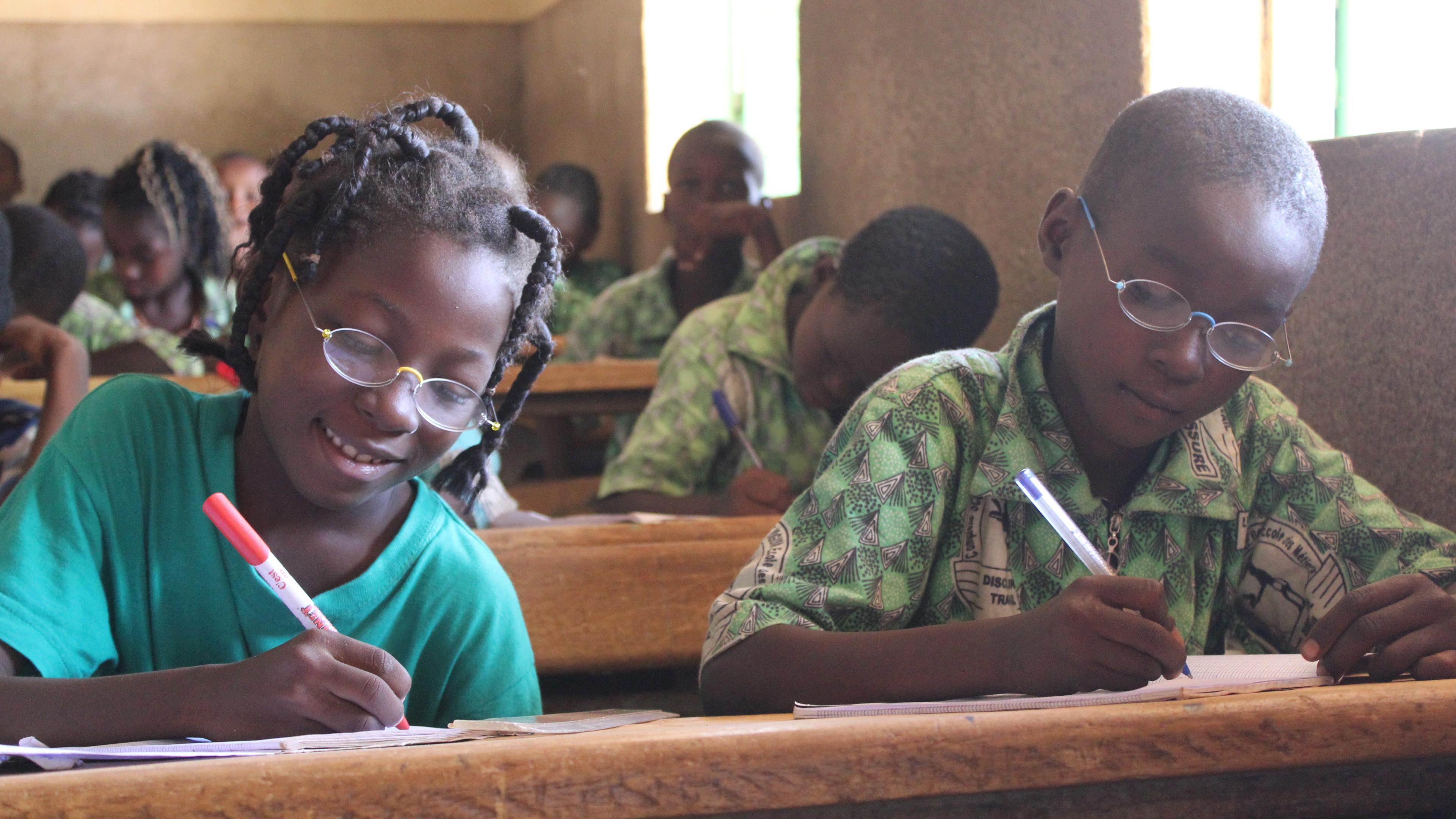 Pupils with OneDollarGlasses writing in the classroom