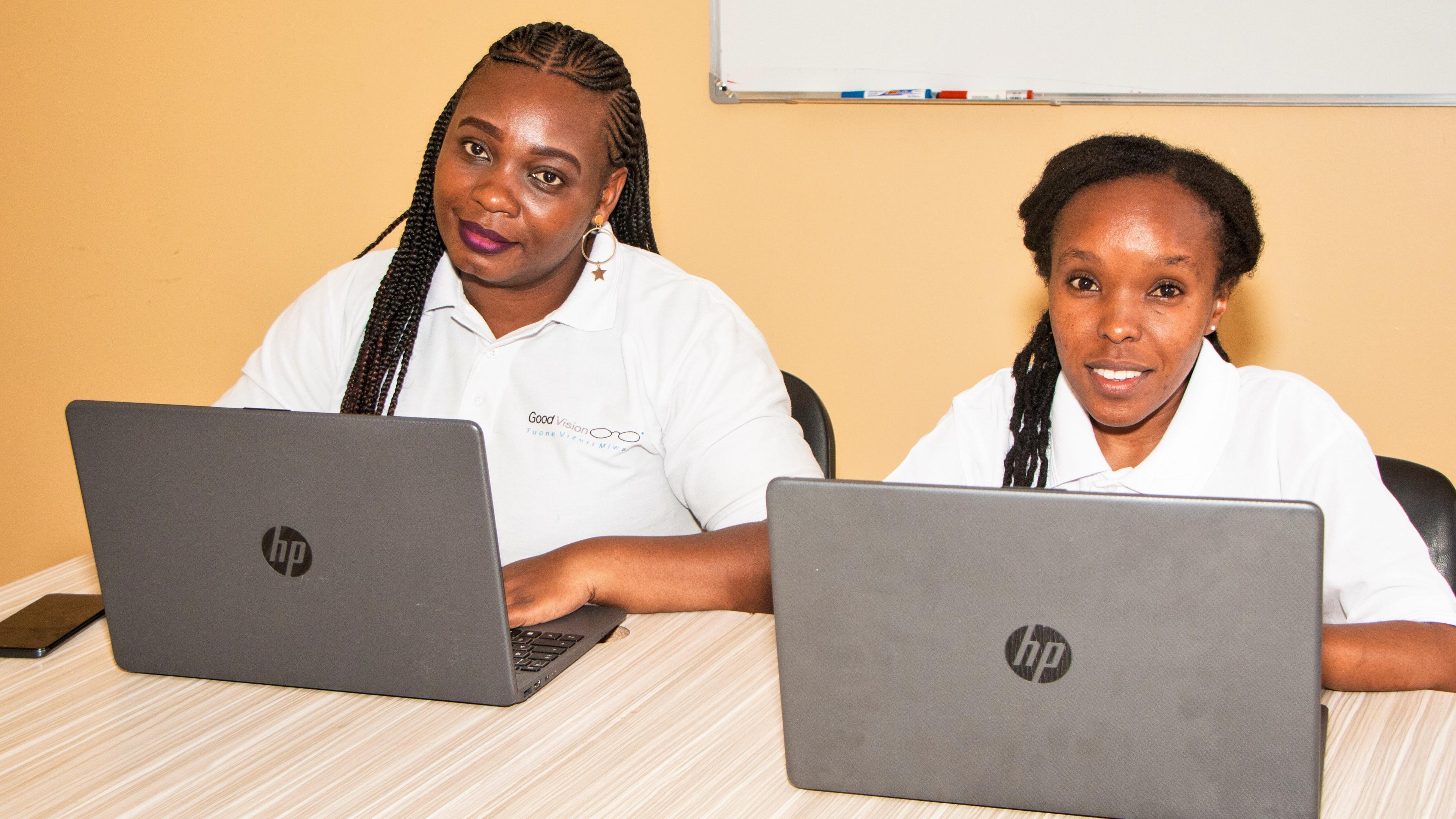 Two GoodVision Kenya employees at their desks