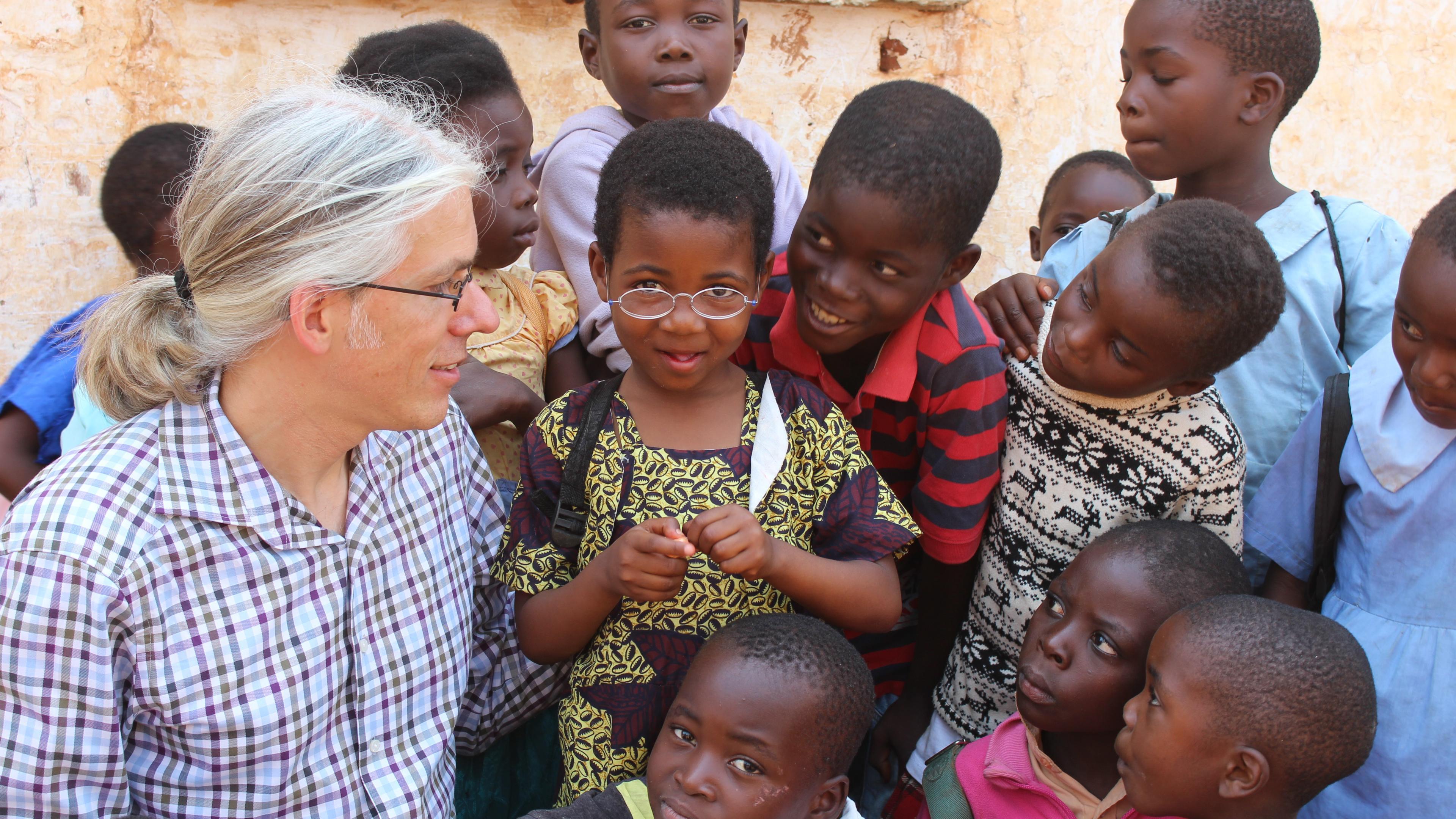 Martin Aufmuth surrounded by children in Malawi