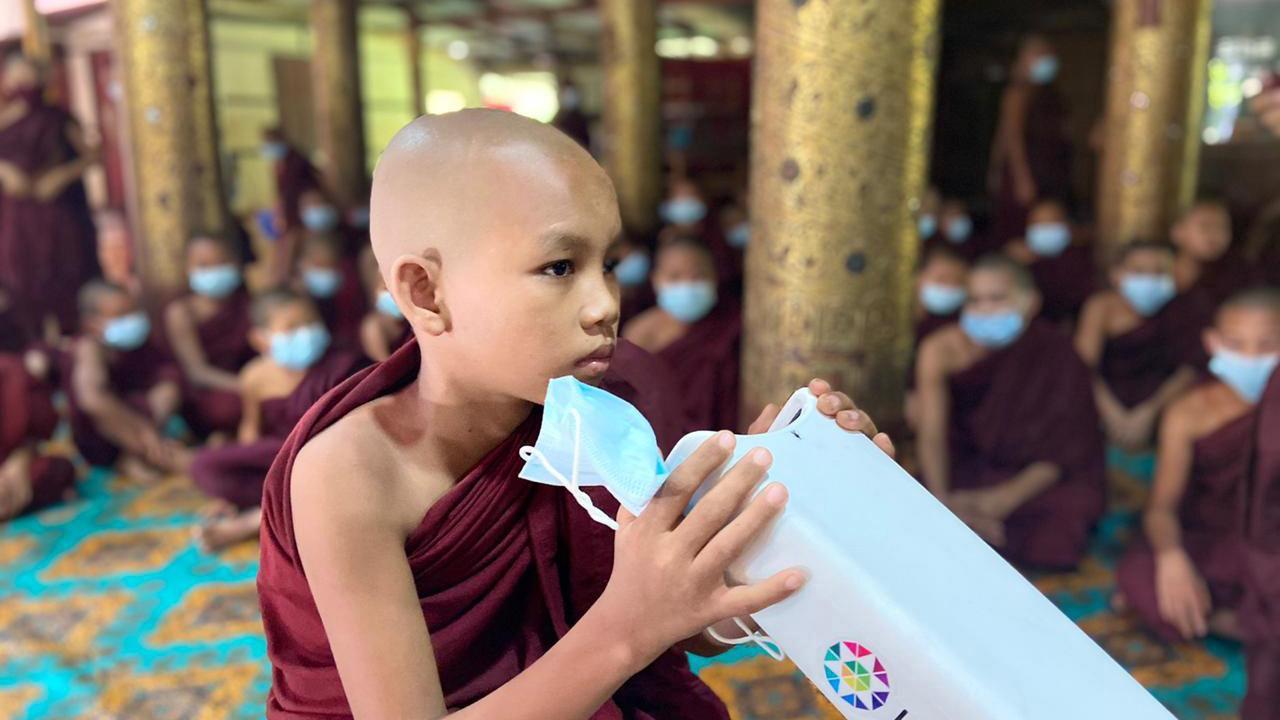 Young Buddhist in Myanmar with autorefraction device