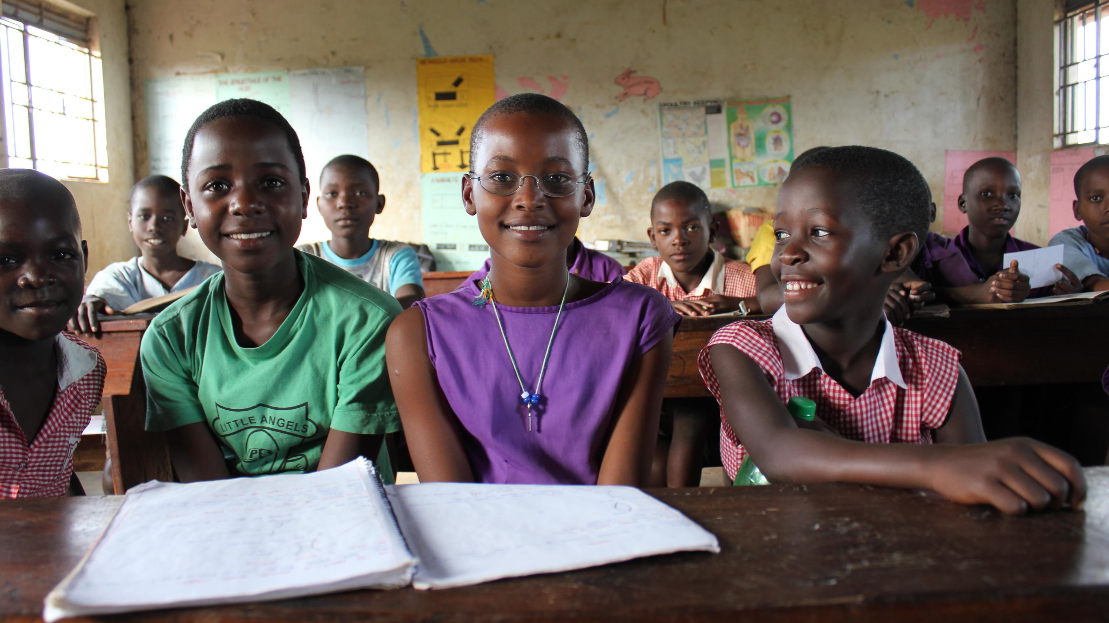 Pupils from Uganda in the classroom, one wearing OneDollarGlasses