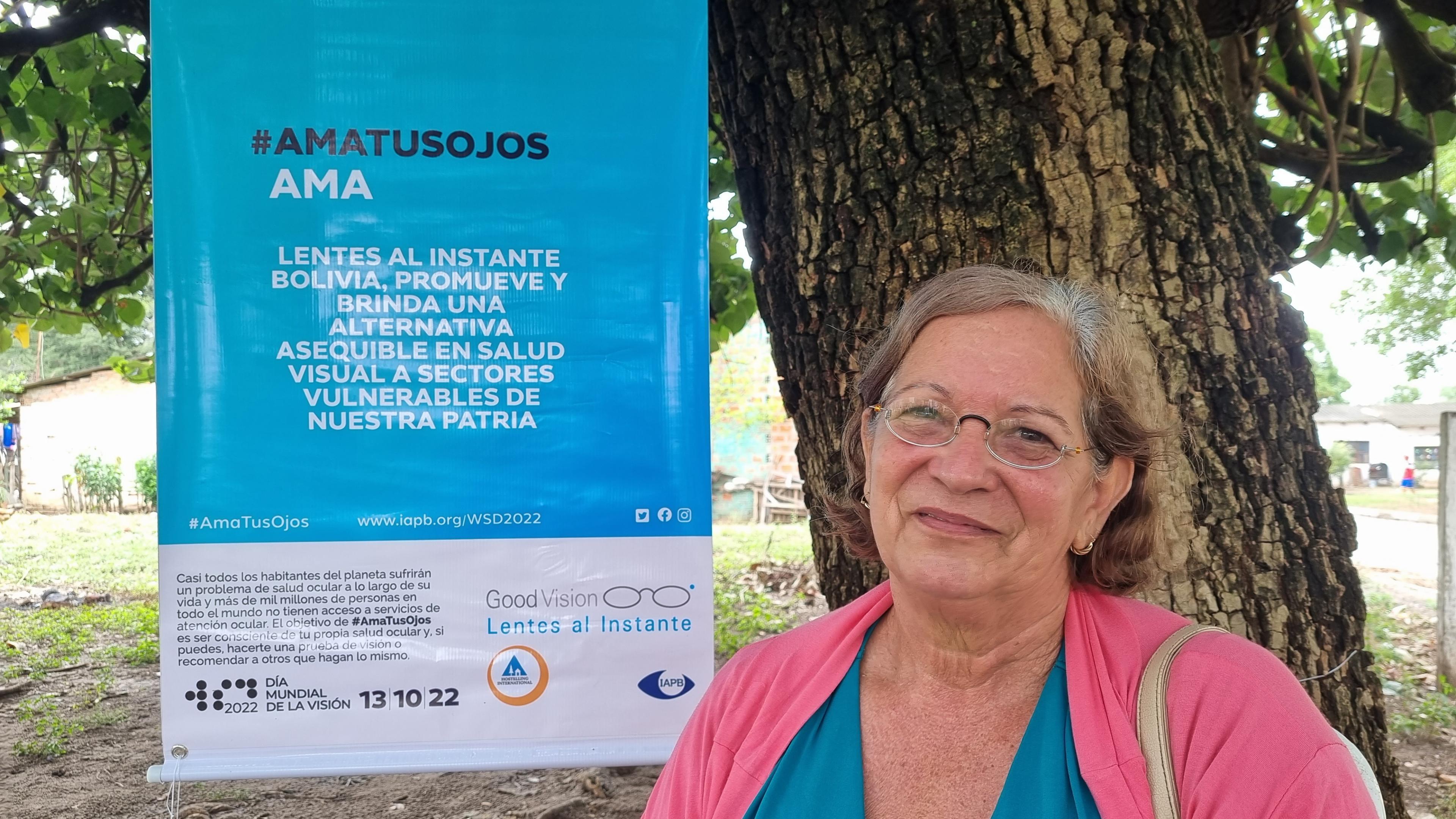 Patient in Bolivia in front of educational poster on the occasion of World Sight Day