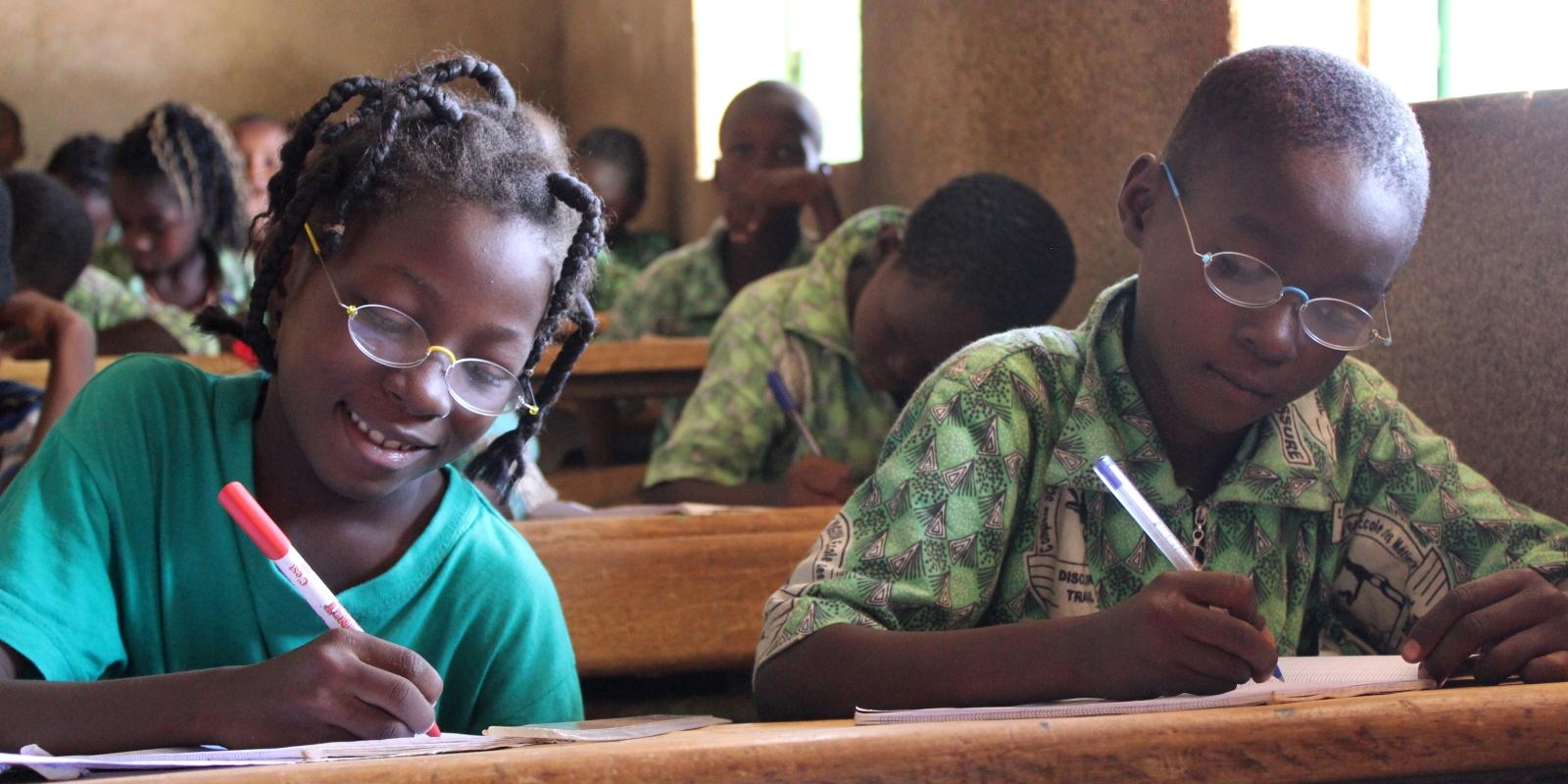 Two pupils writing in Burkina Faso