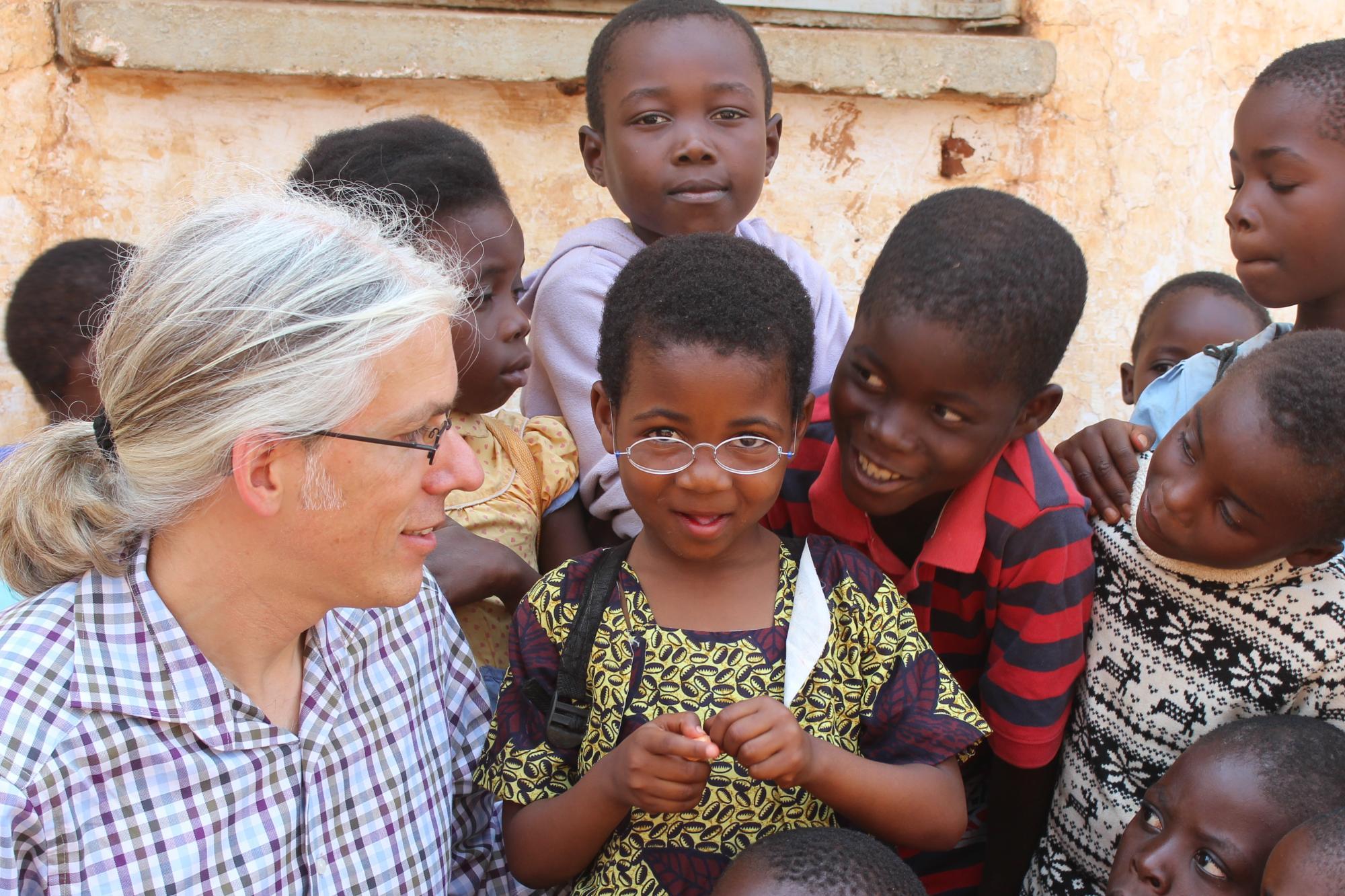 Martin Aufmuth surrounded by several children in Malawi