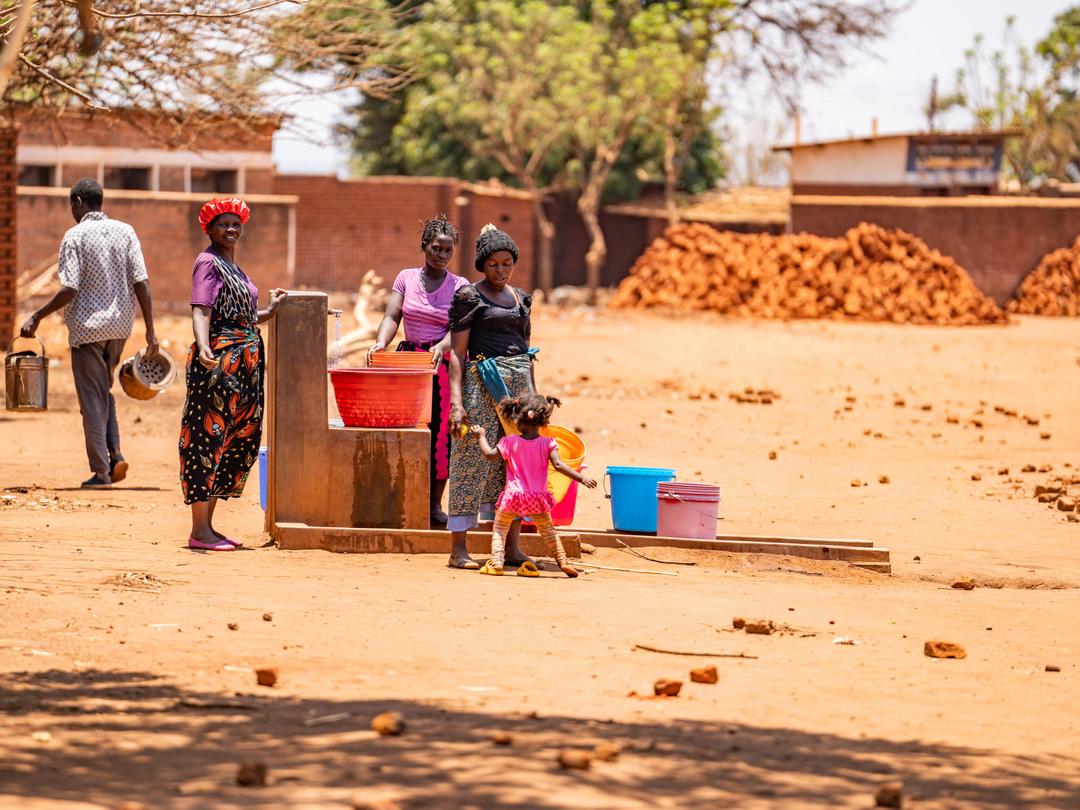 Women at a well in Malawi
