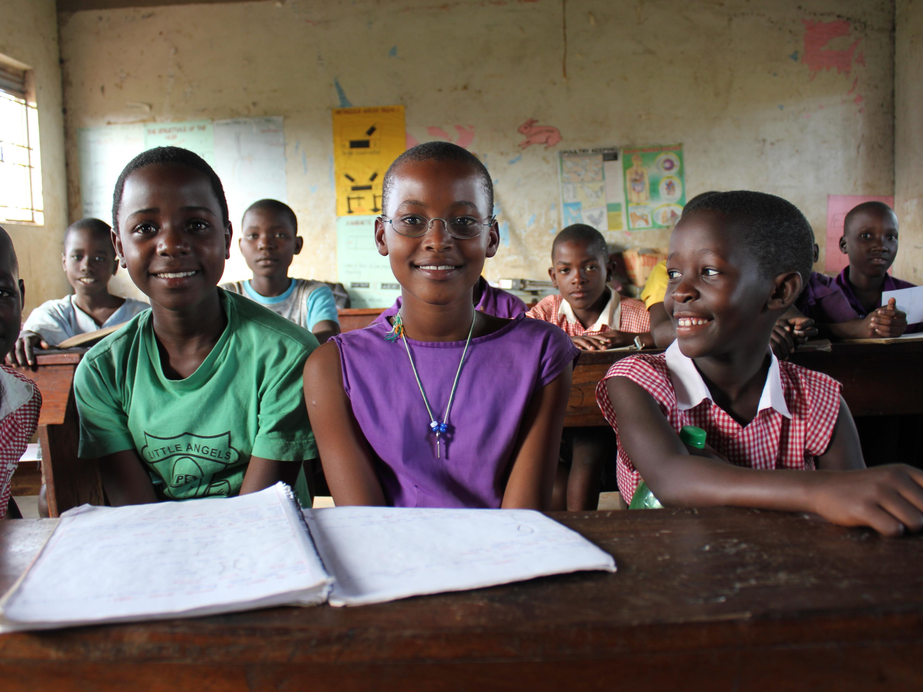 Pupils from Uganda in the classroom, one wearing OneDollarGlasses